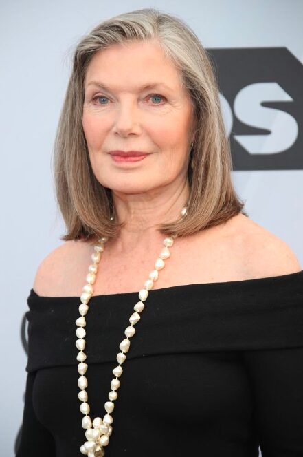 An image of Susan Sullivan smiling confidently, representing her accomplished career and financial success.